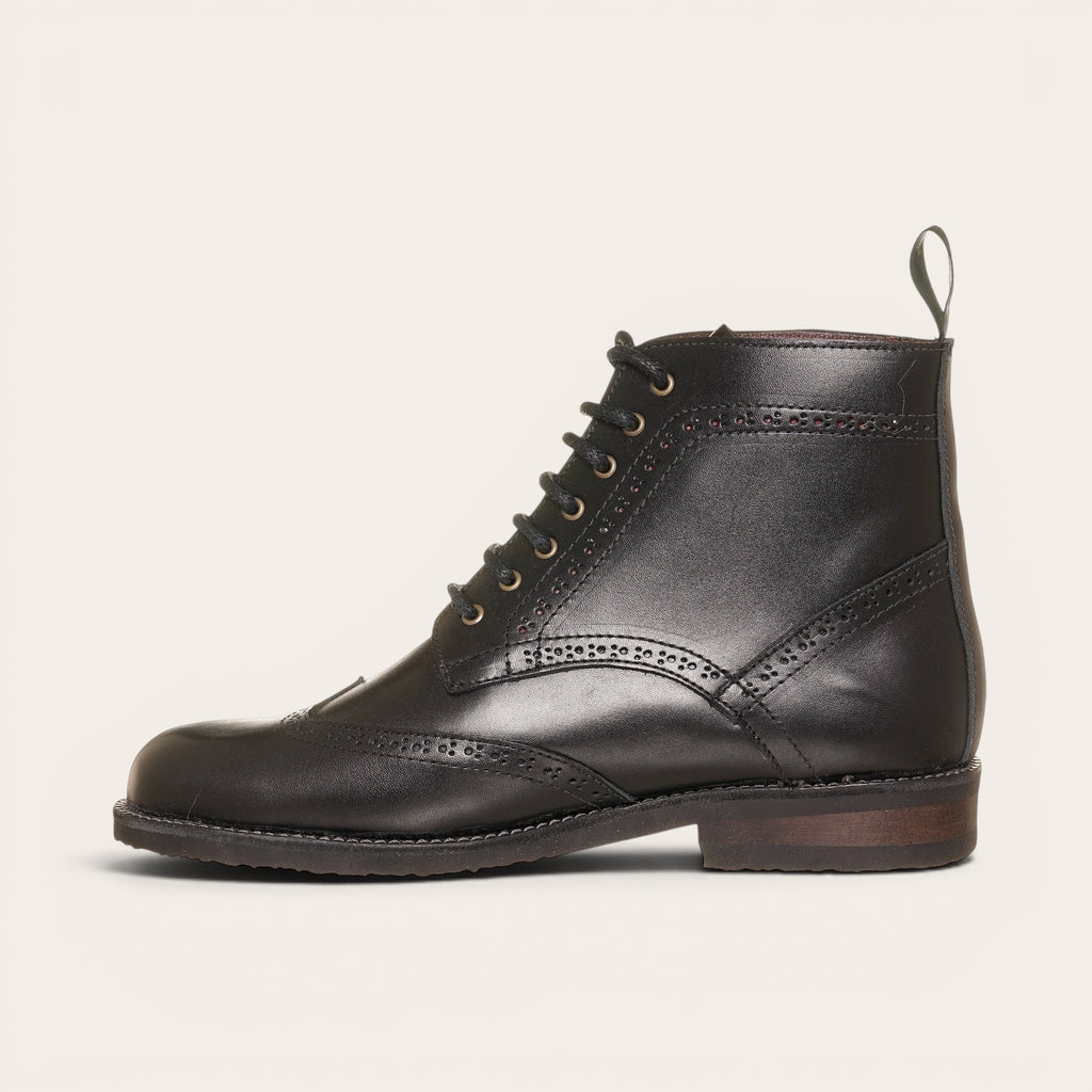 Botín de cuero negro OLKI con cordones, suela negra y detalles brogue. Diseño urbano y elegante.