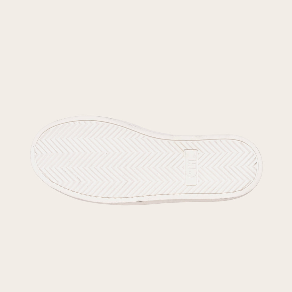 OLKI Zapatilla Calán de planta blanca con patrón de espiga para un agarre óptimo.
