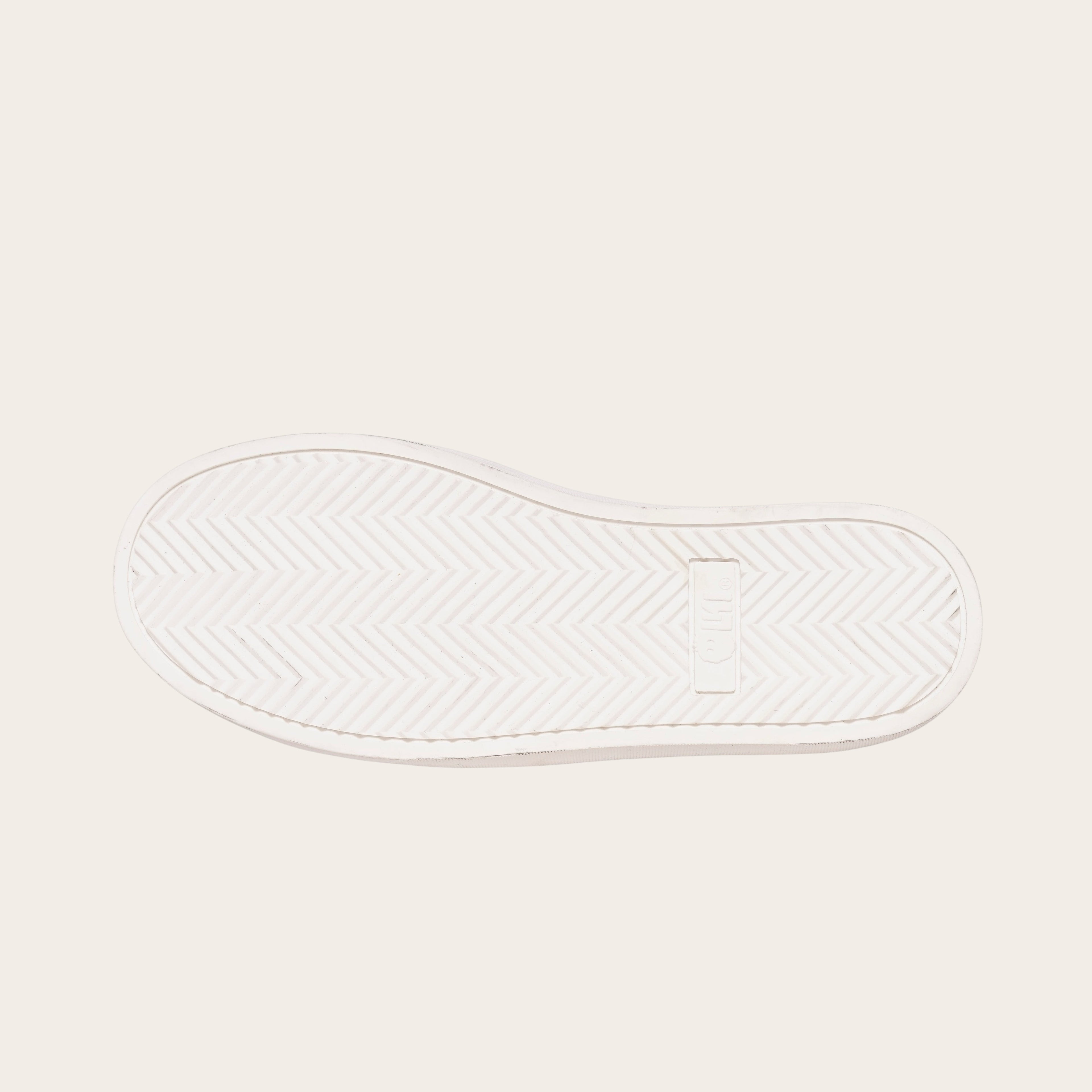 OLKI Zapatilla Calán de planta blanca con patrón de espiga para un agarre óptimo.