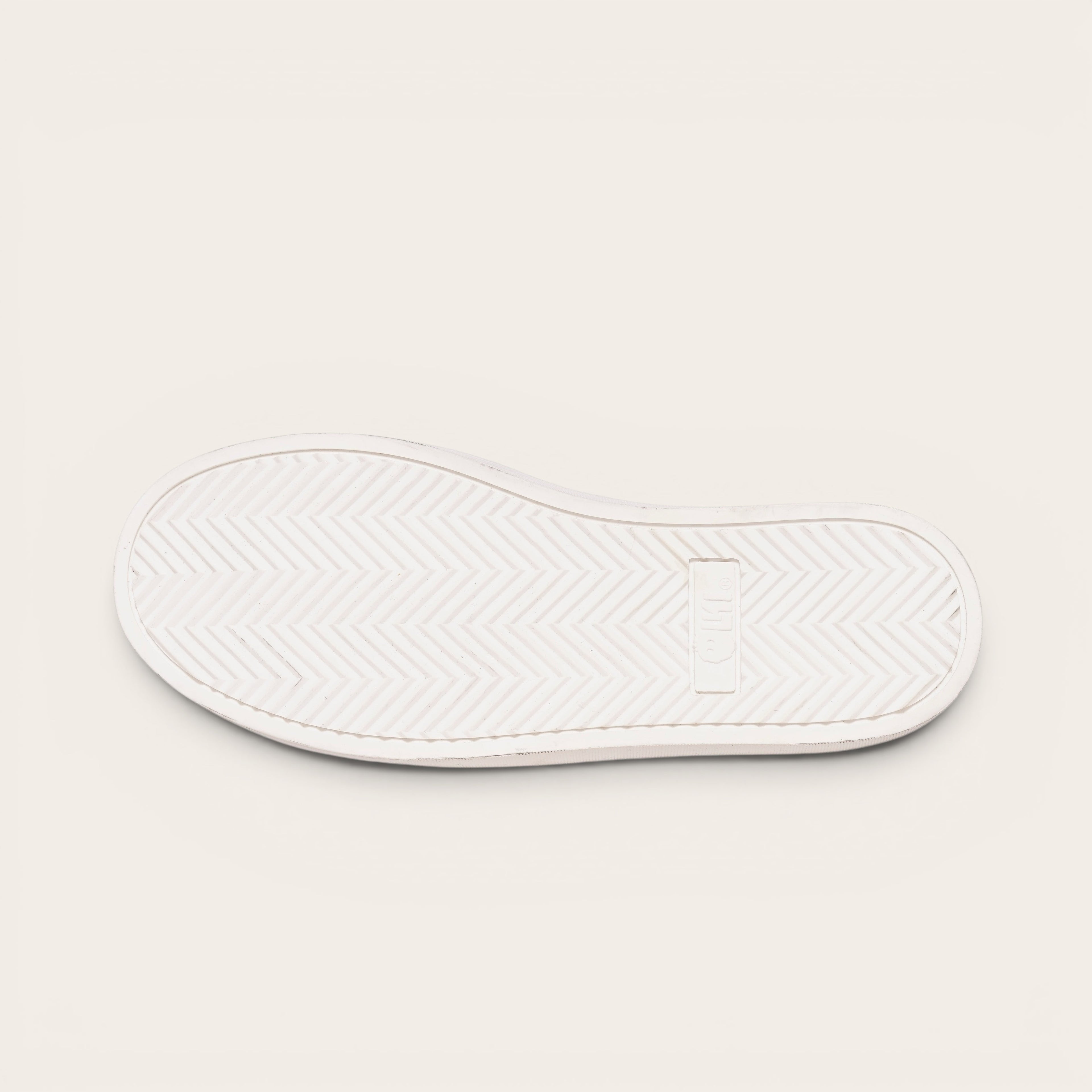 OLKI Zapatilla Calán de planta blanca con patrón de espiga para un agarre óptimo.