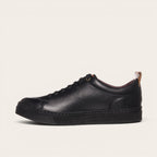 Zapatilla OLKI Calán negra de cuero con cordones y planta negra. Diseño artesanal chileno.