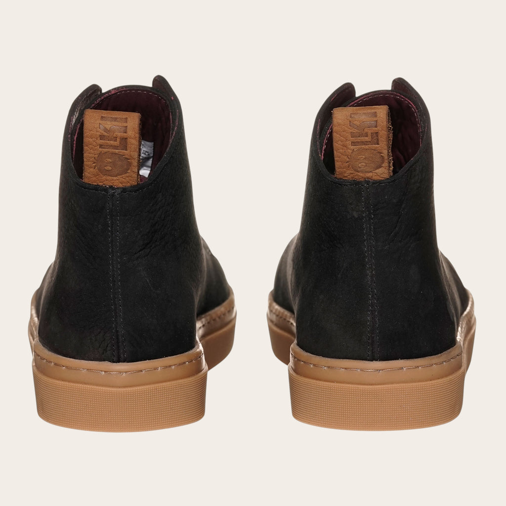 Zapatilla OLKI Manquehue negra de cuero nobuk con cordones de algodón y planta de caucho antideslizante.