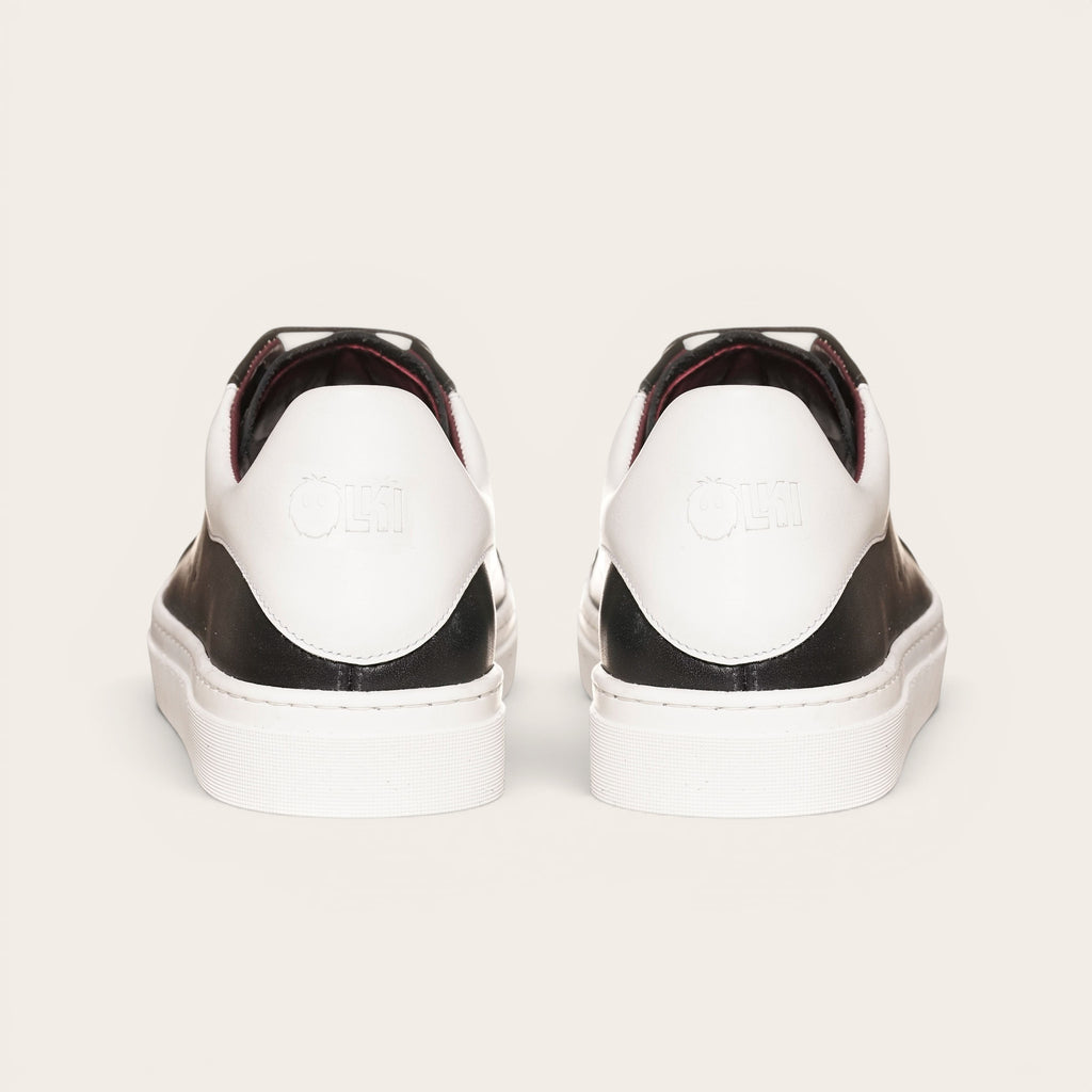 Zapatilla OLKI Nevado negra de cuero con talonera blanca y planta de caucho. Diseño artesanal chileno.
