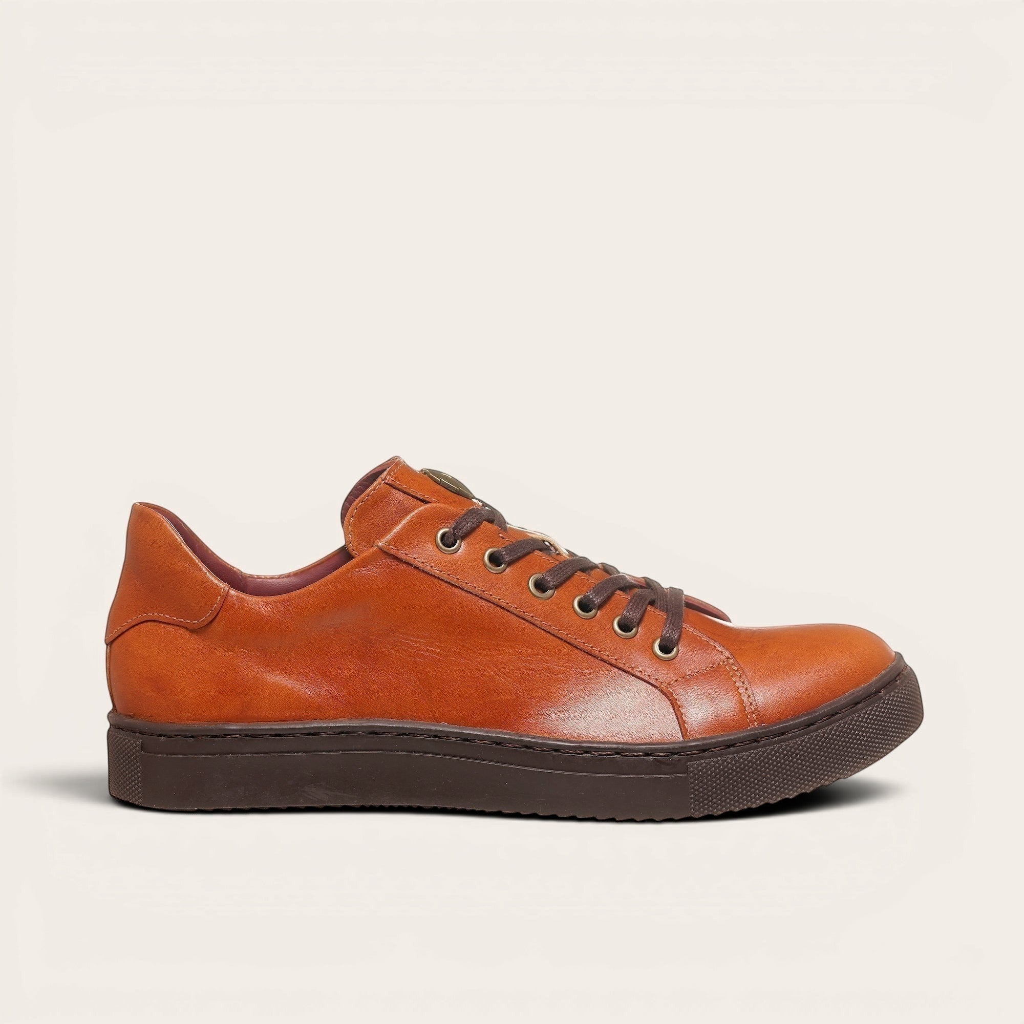 Zapatilla OLKI Tronador tostada de cuero con cordones marrones y suela de caucho chocolate.