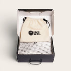 OLKI Zapatilla Tronador Tostado Planta Chocolate, zapatilla de cuero vacuno con forro de cuero natural y suela de caucho antideslizante, presentada en su caja con bolsa protectora.