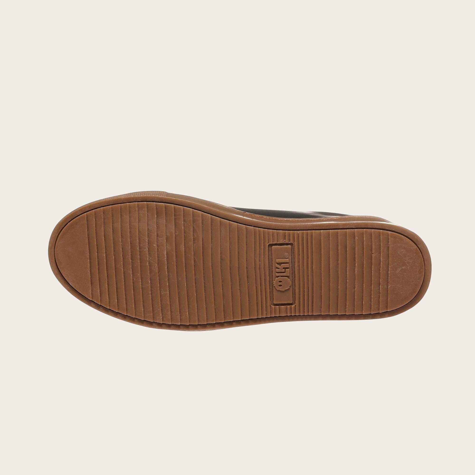 Zapatilla OLKI Tronador negra de cuero vacuno con planta de caucho antideslizante y detalle de logo en la planta.