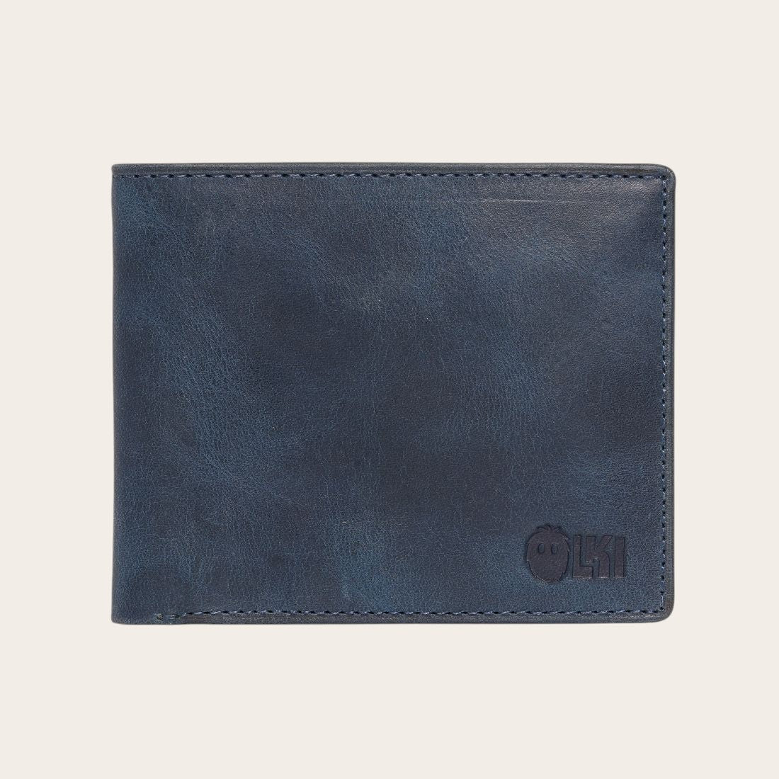 Billetera OLKI Ñuble Azul de cuero con acabado desgastado y logo grabado. Diseño clásico para hombre.