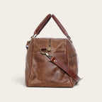 Bolso de viaje compacto OLKI Rahue en cuero natural color café con asas de mano y correa ajustable para hombro