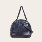 Bolso de viaje OLKI Futaleufu azul marino de cuero con acabado desgastado, asas superiores y correa de hombro.