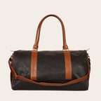 Bolso de viaje OLKI Futaleufu negro y marrón de cuero, con asas y correa de hombro, cierres metálicos envejecidos y costuras reforzadas.