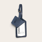 Identificador de equipaje OLKI modelo Huasco en cuero natural color azul con solapa protectora y correa ajustable