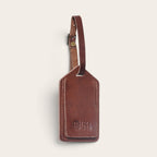 Identificador de equipaje OLKI Huasco en cuero natural color castaño con correa ajustable y logo grabado