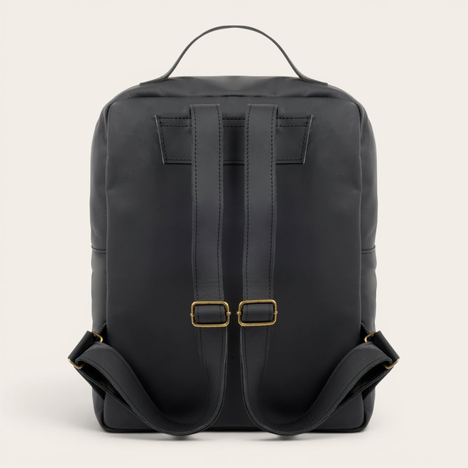 Mochila negra de cuero de vacuno OLKI Toltén con correas ajustables y compartimento para portátil. Diseño minimalista.