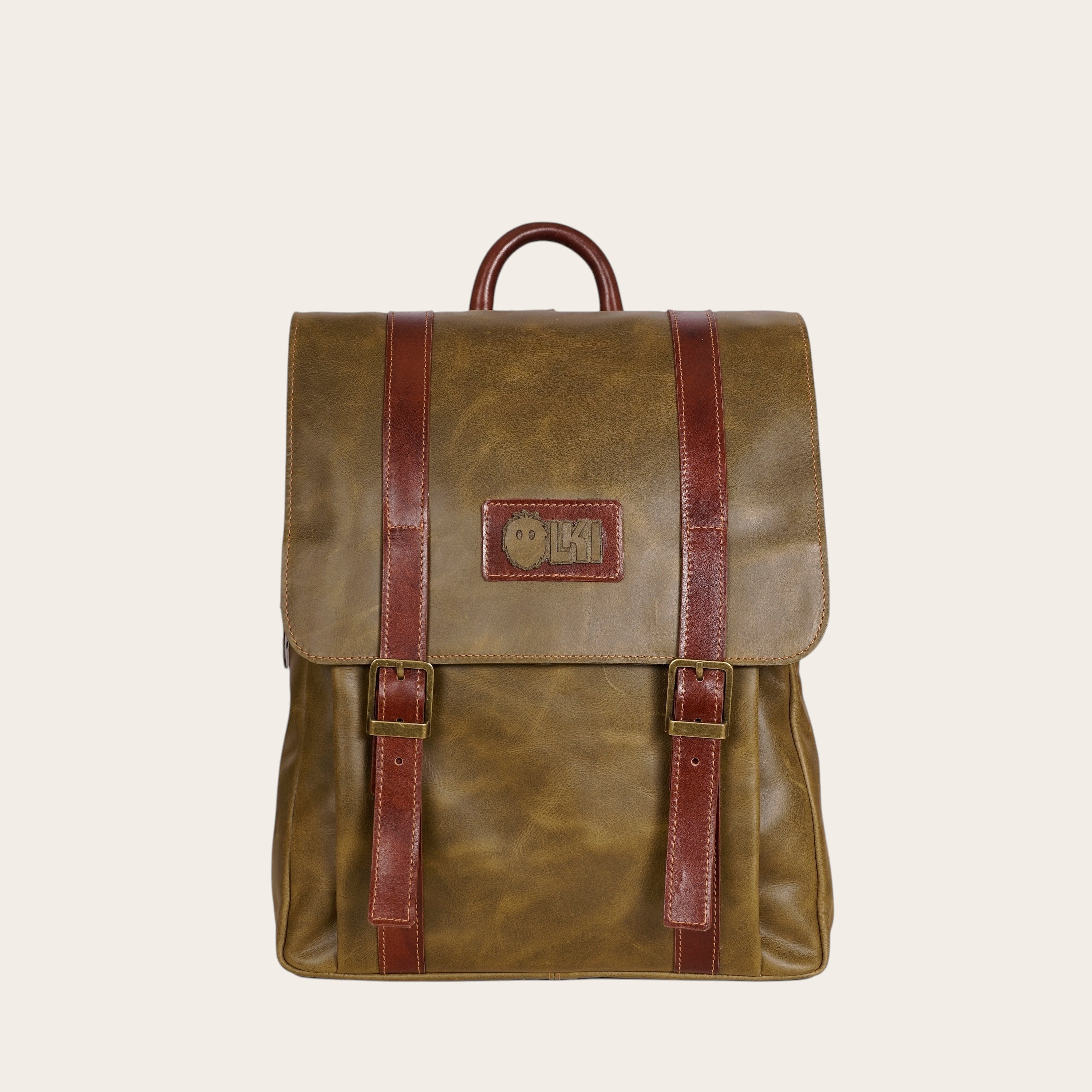 Mochila OLKI Trancura verde de cuero con correas y hebillas marrones, ideal para uso diario y escapadas.