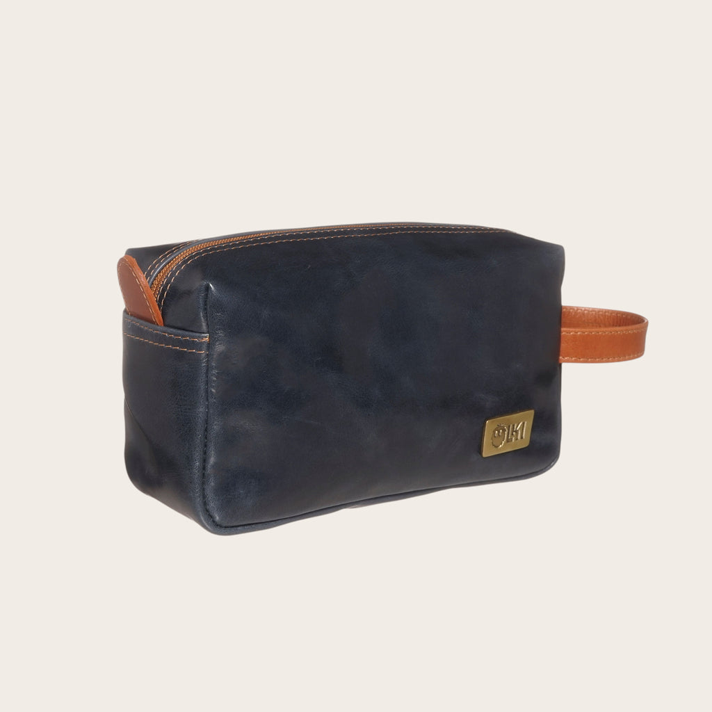 Neceser OLKI Elqui de cuero azul marino y tostado con bolsillo exterior y asa lateral.