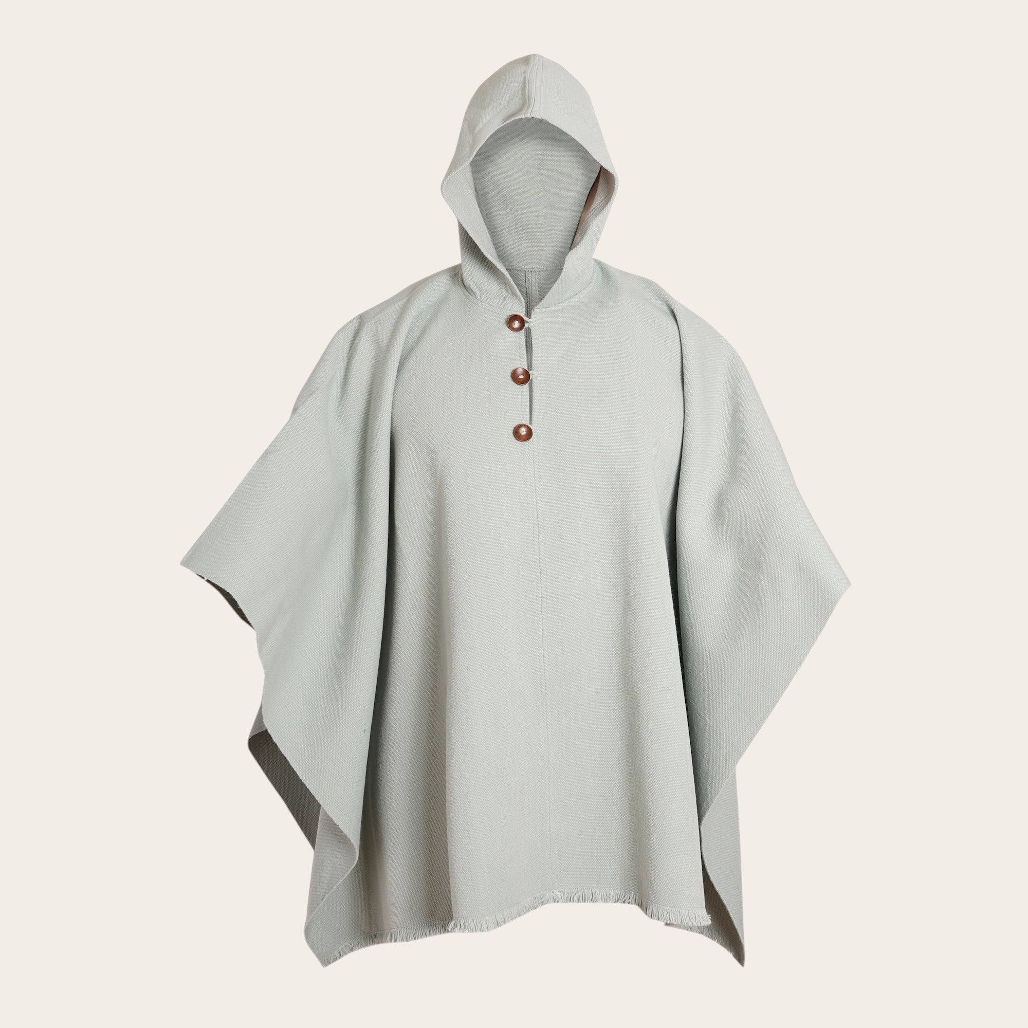 Poncho clásico de lana premium OLKI en color menta con capucha y tres botones de madera.